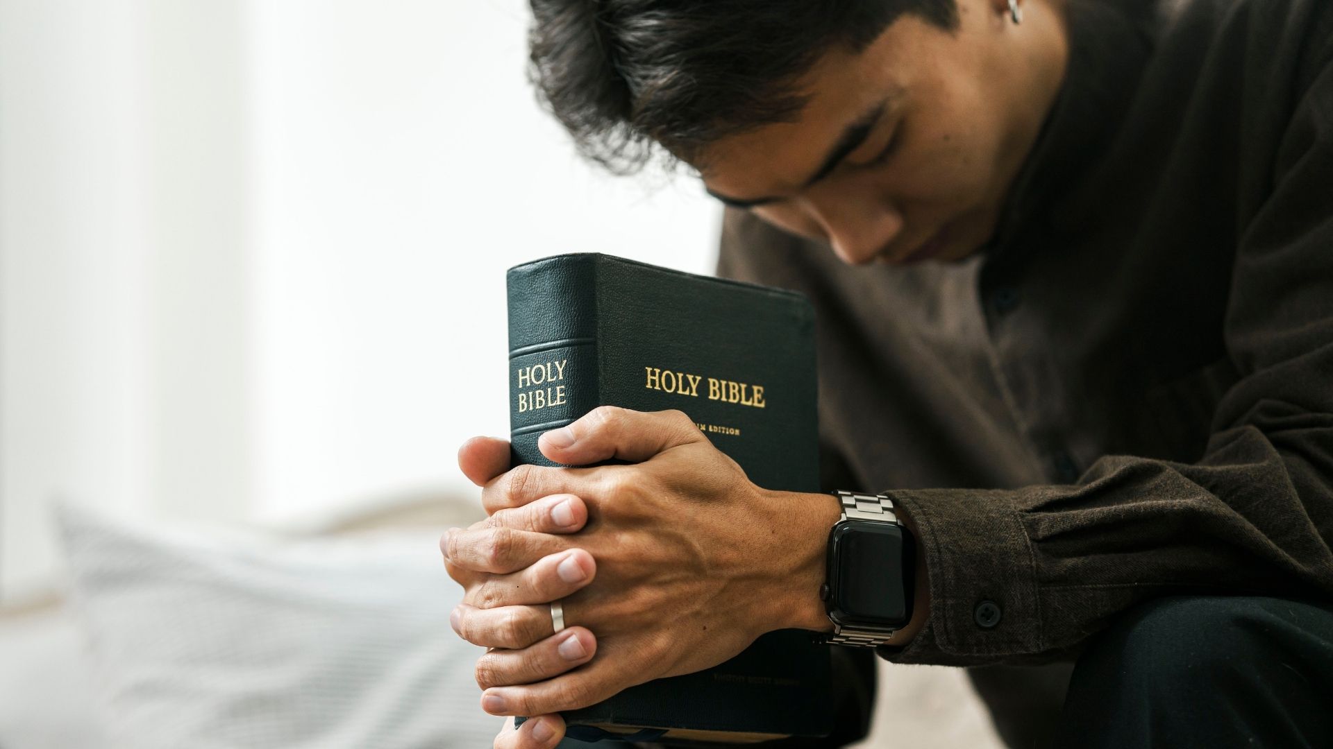 man praying with bible
