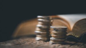 coins next to a bible